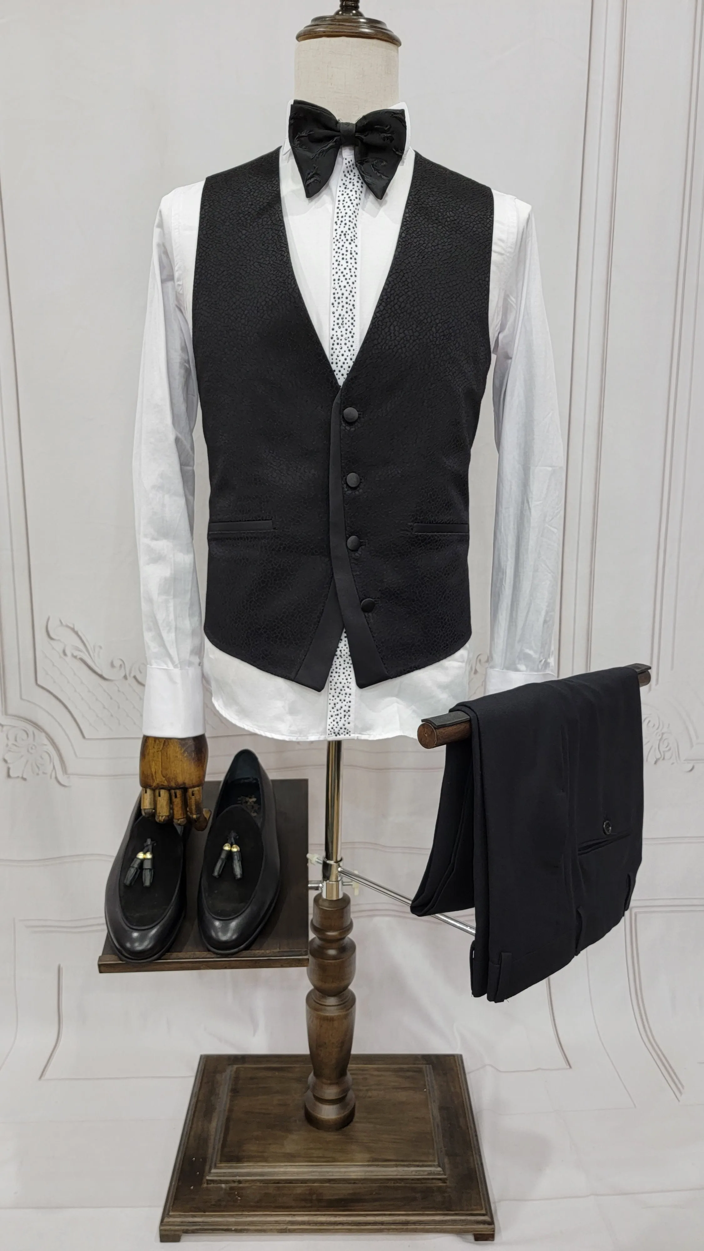 Three Pieces Tuxedo Suit with a Classic Black Satin Lapel, matching bow tie and Black Pants.
