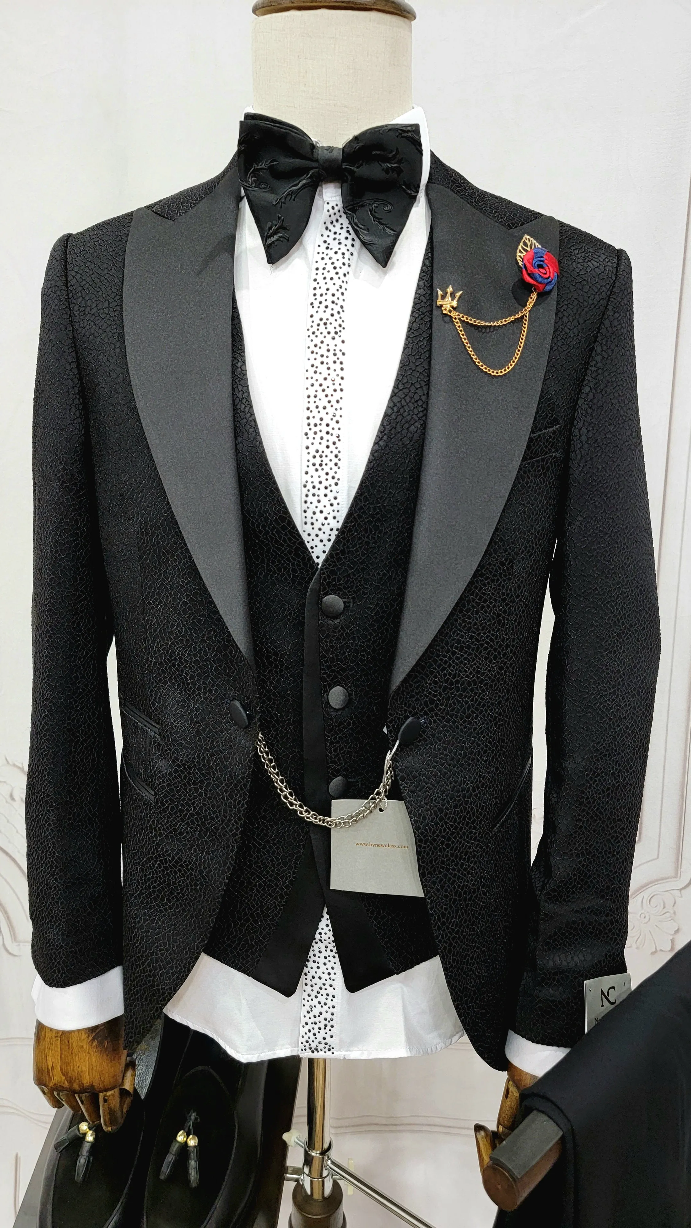 Three Pieces Tuxedo Suit with a Classic Black Satin Lapel, matching bow tie and Black Pants.