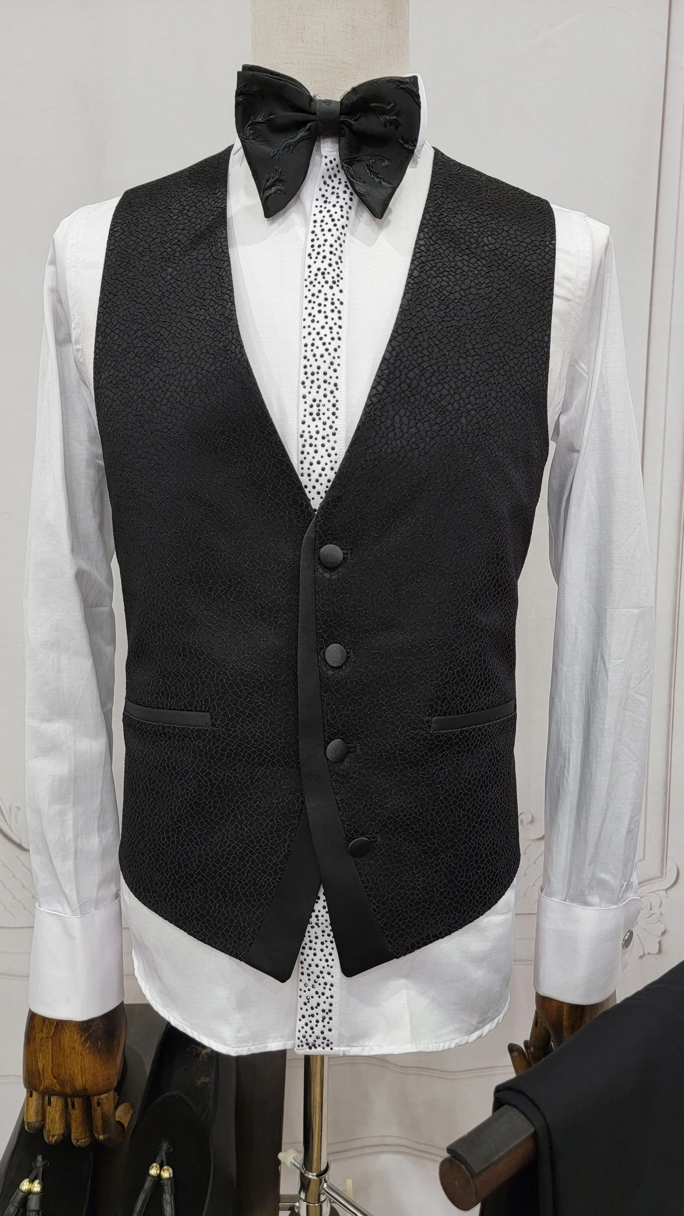 Three Pieces Tuxedo Suit with a Classic Black Satin Lapel, matching bow tie and Black Pants.