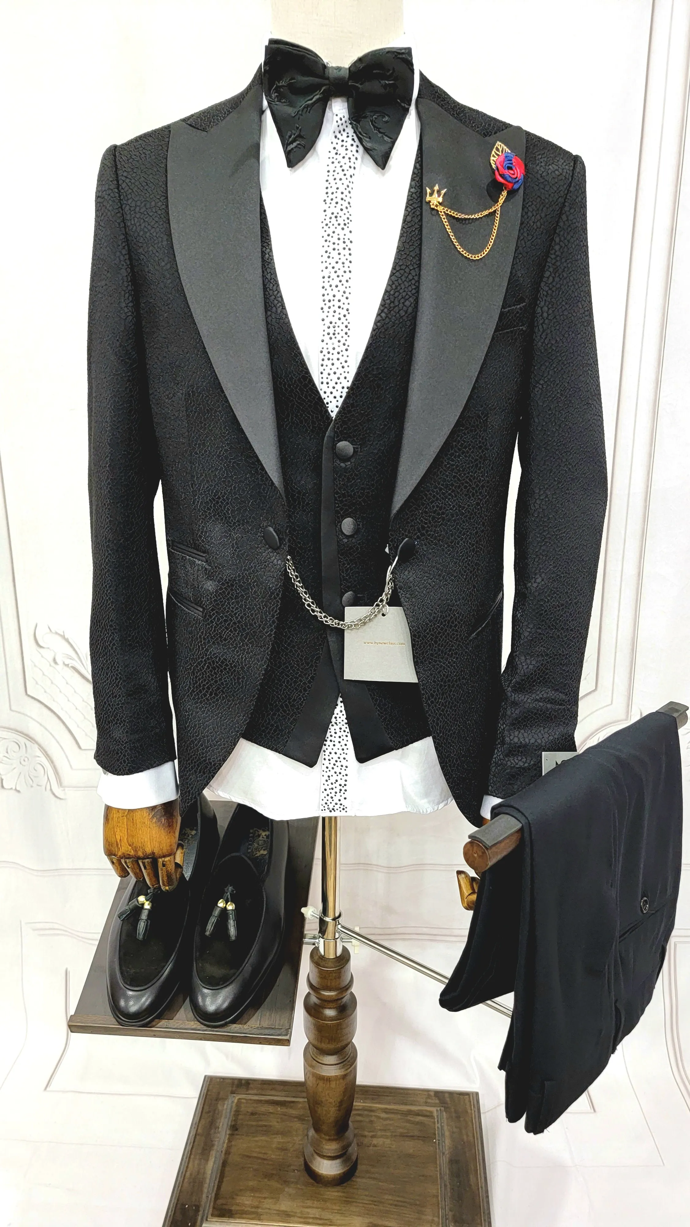 Three Pieces Tuxedo Suit with a Classic Black Satin Lapel, matching bow tie and Black Pants.
